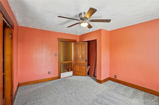 281 S Riverview Ave, Miamisburg, OH 45342 - unfurnished bedroom with carpet floors, baseboards, a textured wall, and ceiling fan