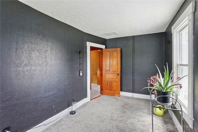 281 S Riverview Ave, Miamisburg, OH 45342 - unfurnished room featuring baseboards, carpet, and a textured ceiling