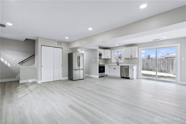 340 S Elm St, Dayton, OH 45449 - interior space featuring appliances with stainless steel finishes, light wood-style floors, light countertops, white cabinetry, and visible vents