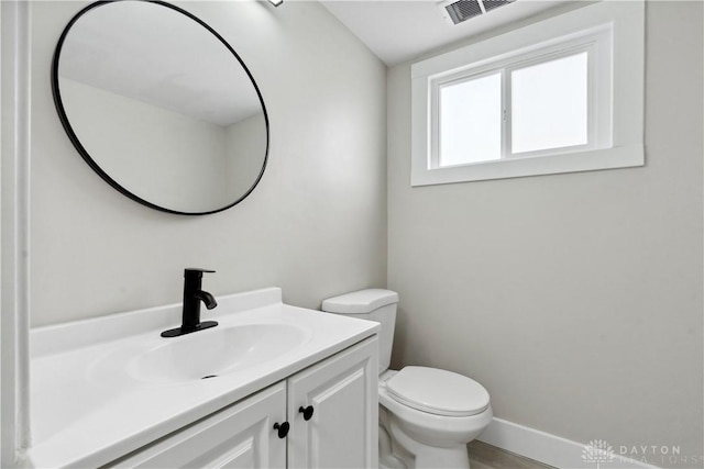 340 S Elm St, Dayton, OH 45449 - half bathroom with visible vents, baseboards, toilet, and vanity