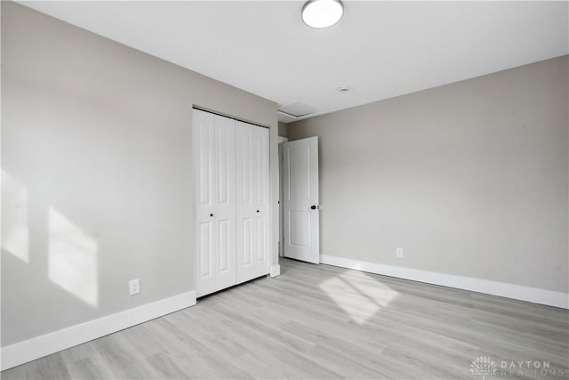 340 S Elm St, Dayton, OH 45449 - unfurnished bedroom with baseboards, a closet, and wood finished floors