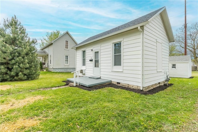 rear view of house with a lawn