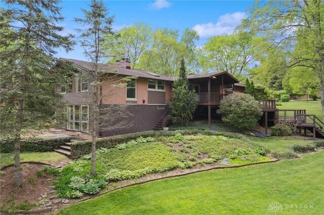 view of yard with a deck, a sunroom, and stairway