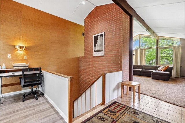 interior space with baseboards, light tile patterned floors, and high vaulted ceiling