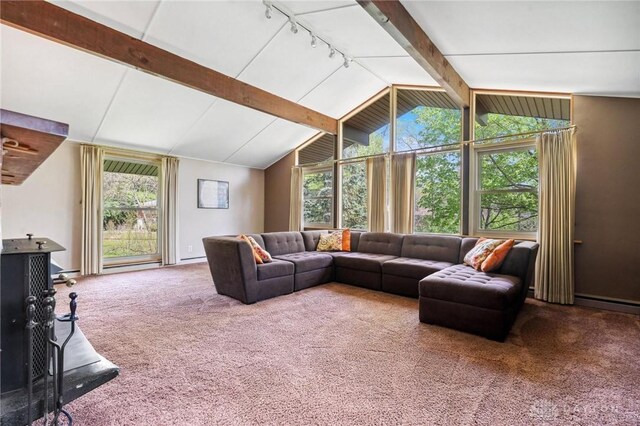 living room with vaulted ceiling with beams, rail lighting, and carpet flooring