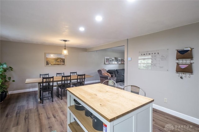dining space with baseboards, recessed lighting, and wood finished floors