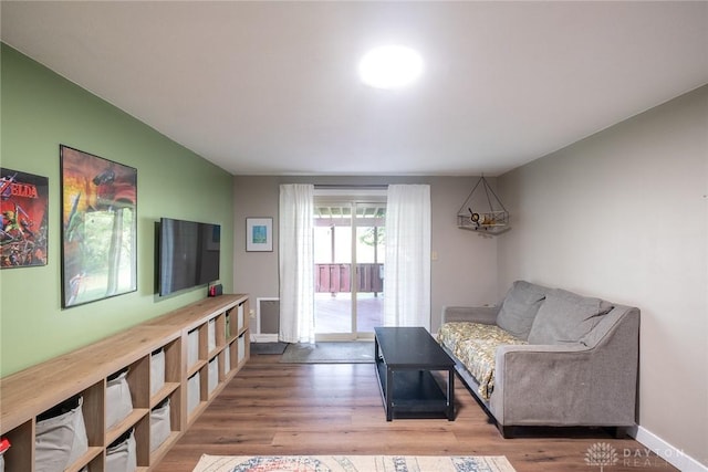 living room featuring baseboards and wood finished floors
