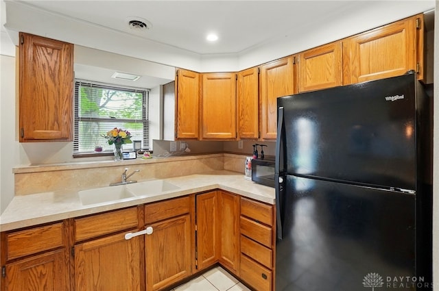 813 Kenosha Rd, Kettering, OH 45429 - kitchen featuring a sink, brown cabinets, black appliances, and light countertops