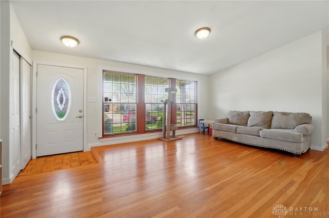 foyer entrance with baseboards and light wood finished floors