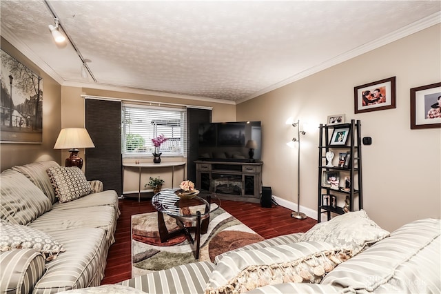 living room featuring crown molding, baseboards, track lighting, and wood finished floors