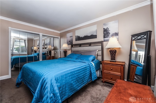 bedroom with crown molding, multiple closets, and carpet