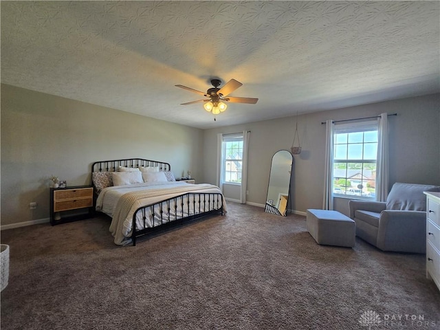bedroom with baseboards, ceiling fan, carpet flooring, and a textured ceiling