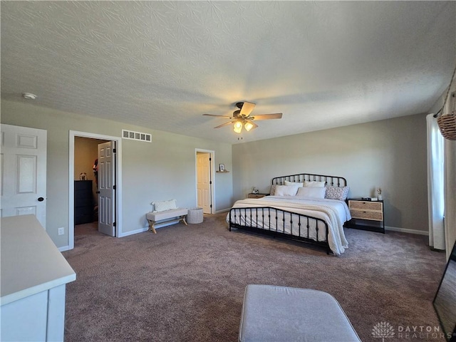 carpeted bedroom featuring visible vents, a textured ceiling, baseboards, and ceiling fan