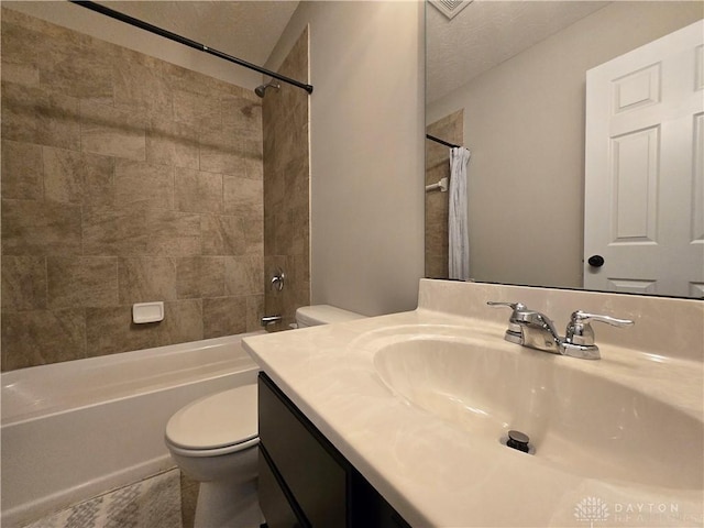 bathroom with vanity, shower / bath combination with curtain, and toilet