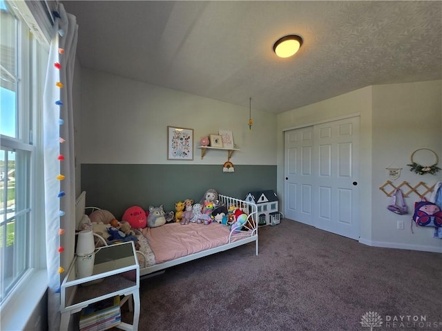 bedroom with carpet floors and baseboards