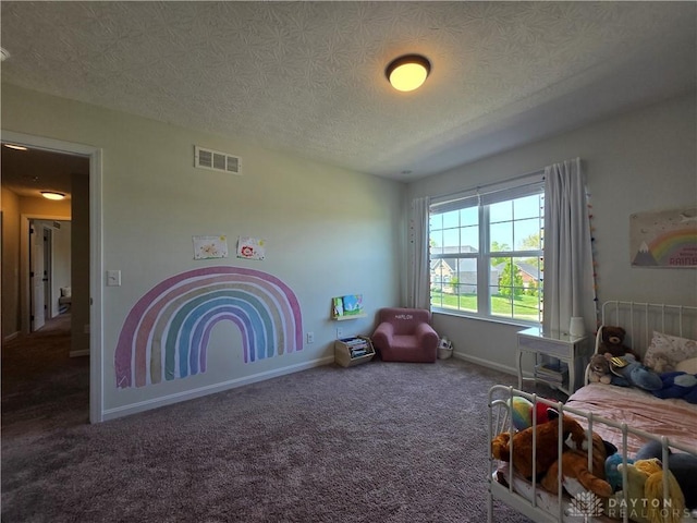 carpeted bedroom with a textured ceiling, baseboards, and visible vents