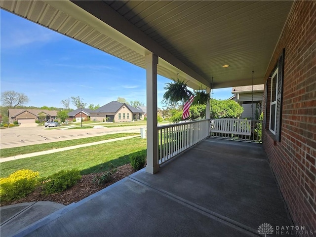 view of patio / terrace featuring a porch and a residential view