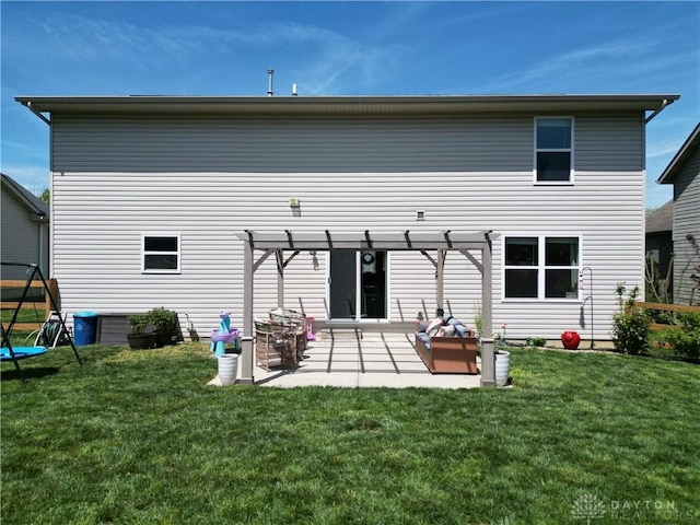 rear view of house with a lawn, a pergola, and a patio area