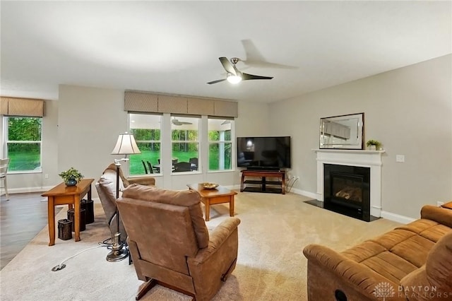 1152 Sarah Freeman Dr, Dayton, OH 45458 - living room featuring ceiling fan, a fireplace with flush hearth, and baseboards