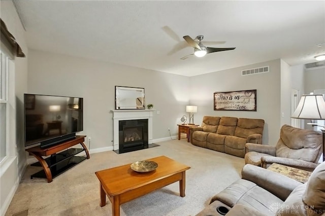 1152 Sarah Freeman Dr, Dayton, OH 45458 - living area with ceiling fan, light carpet, baseboards, a fireplace with flush hearth, and visible vents