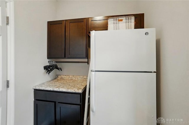 1152 Sarah Freeman Dr, Dayton, OH 45458 - kitchen featuring freestanding refrigerator and dark brown cabinets