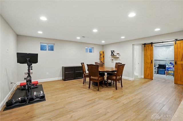 1152 Sarah Freeman Dr, Dayton, OH 45458 - dining room featuring light wood-style floors, baseboards, recessed lighting, and a barn door