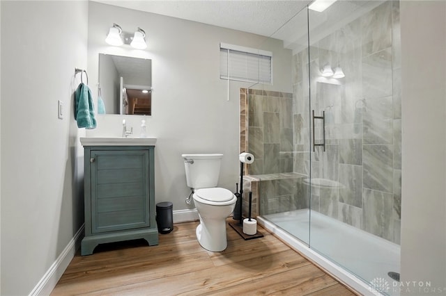 1152 Sarah Freeman Dr, Dayton, OH 45458 - full bathroom with vanity, toilet, baseboards, a shower stall, and wood finished floors