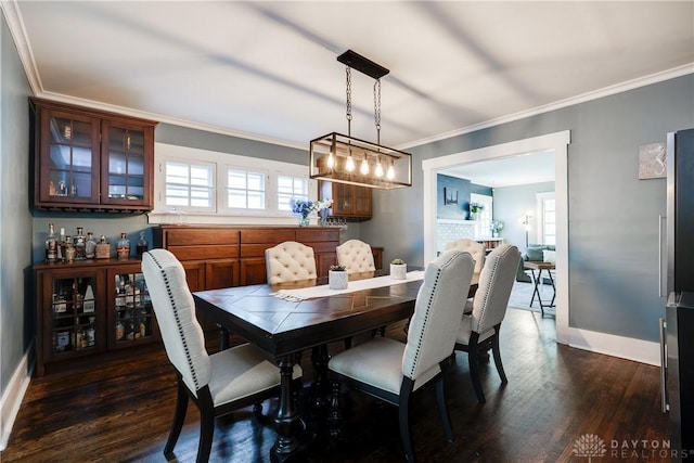 94 Patterson Rd, Oakwood, OH 45419 - dining room featuring baseboards, ornamental molding, and dark wood-style floors