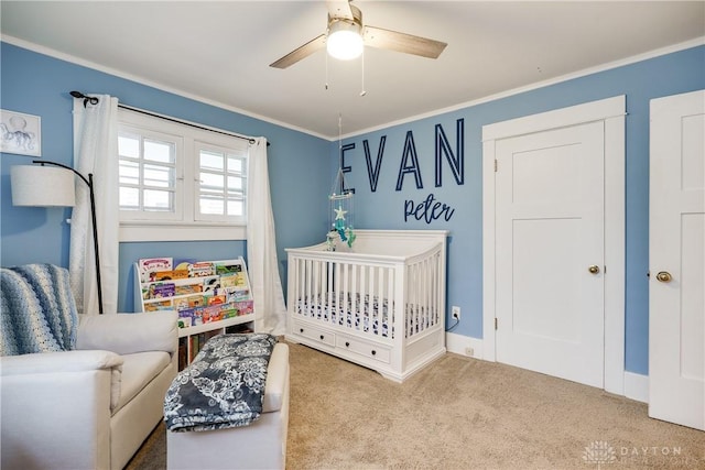 94 Patterson Rd, Oakwood, OH 45419 - carpeted bedroom featuring crown molding, a crib, ceiling fan, and baseboards