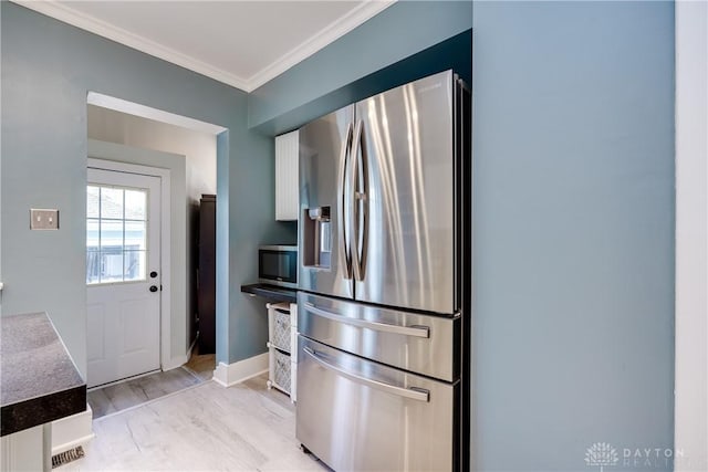 94 Patterson Rd, Oakwood, OH 45419 - kitchen with crown molding, stainless steel appliances, baseboards, white cabinetry, and light wood-type flooring