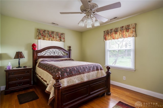 9550 Paragon Rd, Dayton, OH 45458 - bedroom with baseboards, a ceiling fan, wood finished floors, and visible vents