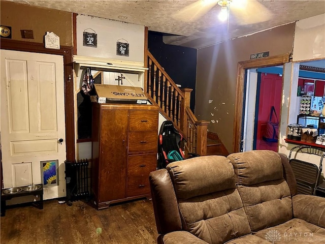 living room featuring ceiling fan, stairs, and wood finished floors