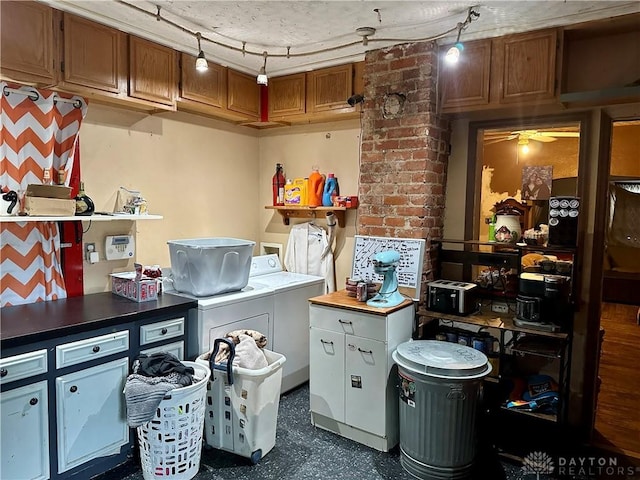 laundry room with laundry area, ceiling fan, washing machine and dryer, and dark floors