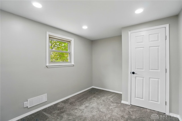 carpeted empty room with visible vents, recessed lighting, and baseboards