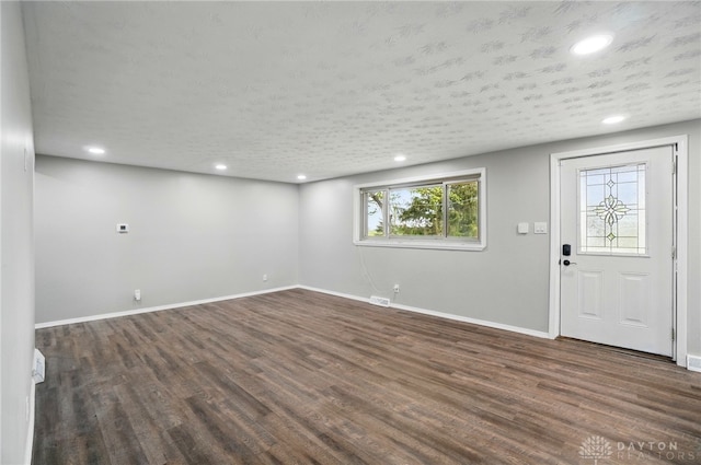 basement with baseboards and dark wood-style flooring