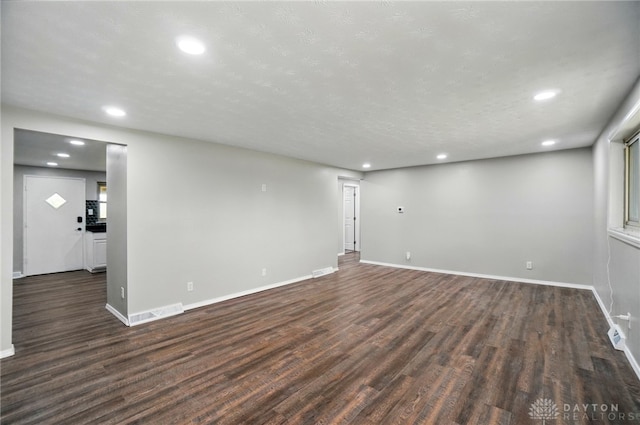 basement featuring recessed lighting, baseboards, and dark wood finished floors