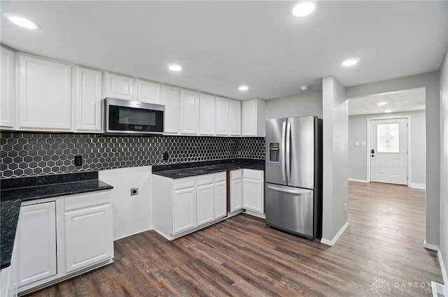 kitchen featuring dark wood-style floors, white cabinets, dark countertops, and stainless steel appliances