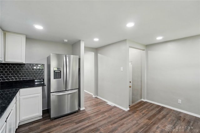 kitchen featuring dark wood finished floors, dark countertops, white cabinets, and stainless steel refrigerator with ice dispenser