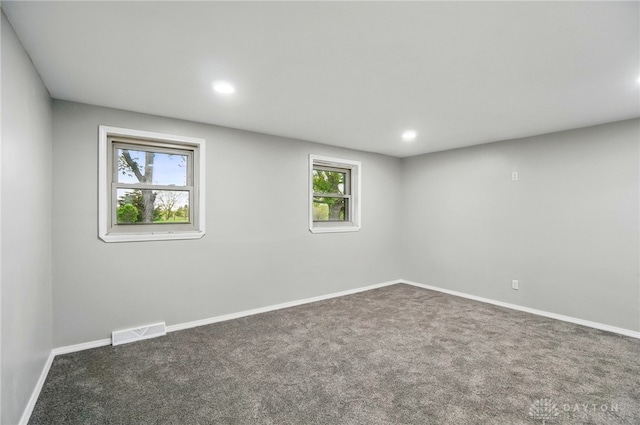 carpeted spare room featuring visible vents, recessed lighting, baseboards, and a healthy amount of sunlight