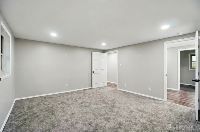 interior space with carpet floors, recessed lighting, and baseboards