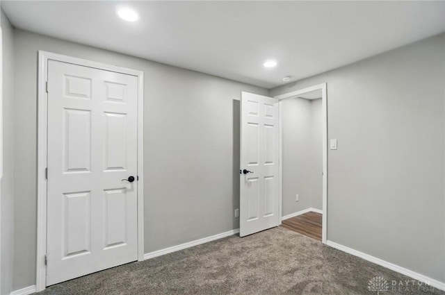 unfurnished bedroom featuring carpet floors, baseboards, and recessed lighting