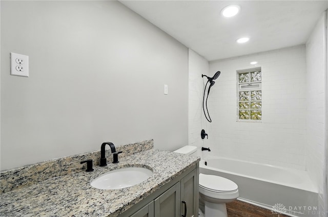 full bathroom with vanity, tub / shower combination, wood finished floors, toilet, and recessed lighting