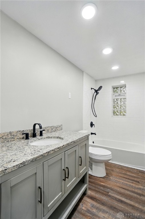full bathroom with bathtub / shower combination, vanity, toilet, recessed lighting, and wood finished floors
