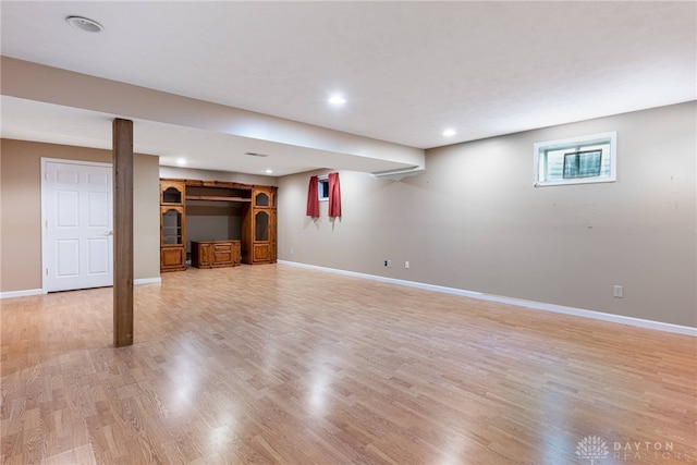 below grade area featuring baseboards, recessed lighting, and light wood-style flooring