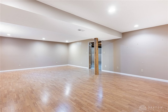 finished below grade area featuring visible vents, recessed lighting, light wood finished floors, and baseboards
