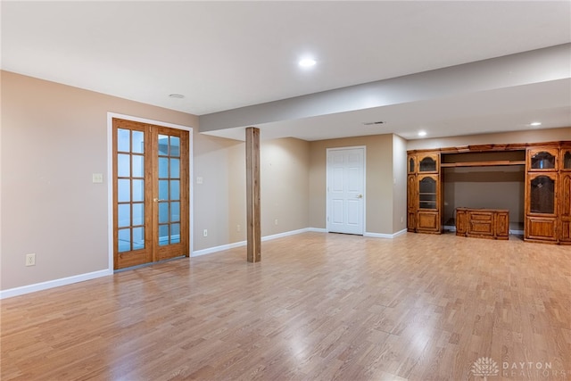 unfurnished living room featuring recessed lighting, baseboards, french doors, and light wood-type flooring