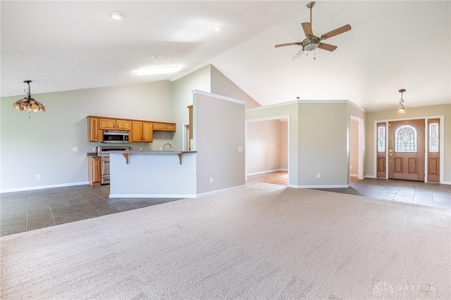 unfurnished living room featuring dark colored carpet, a ceiling fan, baseboards, and high vaulted ceiling