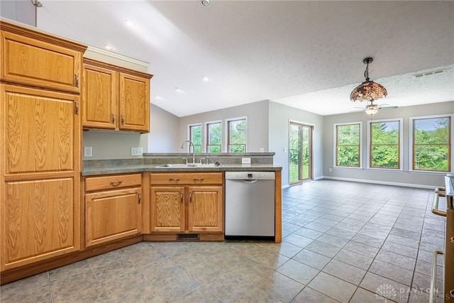 kitchen with brown cabinets, a sink, dishwasher, a peninsula, and lofted ceiling