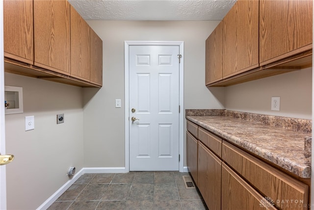 clothes washing area with cabinet space, washer hookup, electric dryer hookup, baseboards, and visible vents