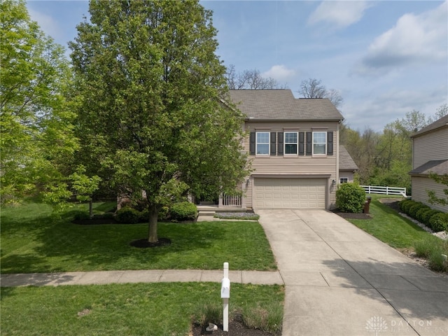 obstructed view of property with fence, an attached garage, driveway, and a front yard